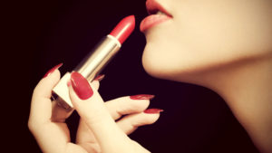 applying red lipstick for beauty makeover